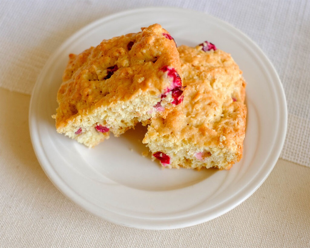White plate with cranberry oatmeal muffins.