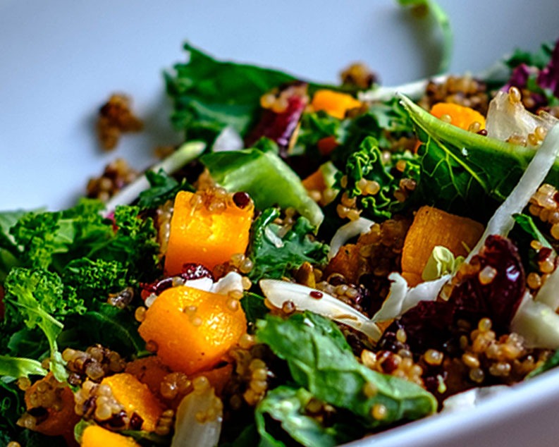 Bowl of quinoa salad with kale and butternut squash.