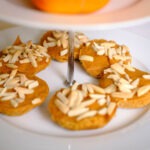 round white plate with persimmon almond muffins.
