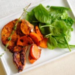 Balsamic Glazed Pork chops with sliced persimmons and sauteed spinach.