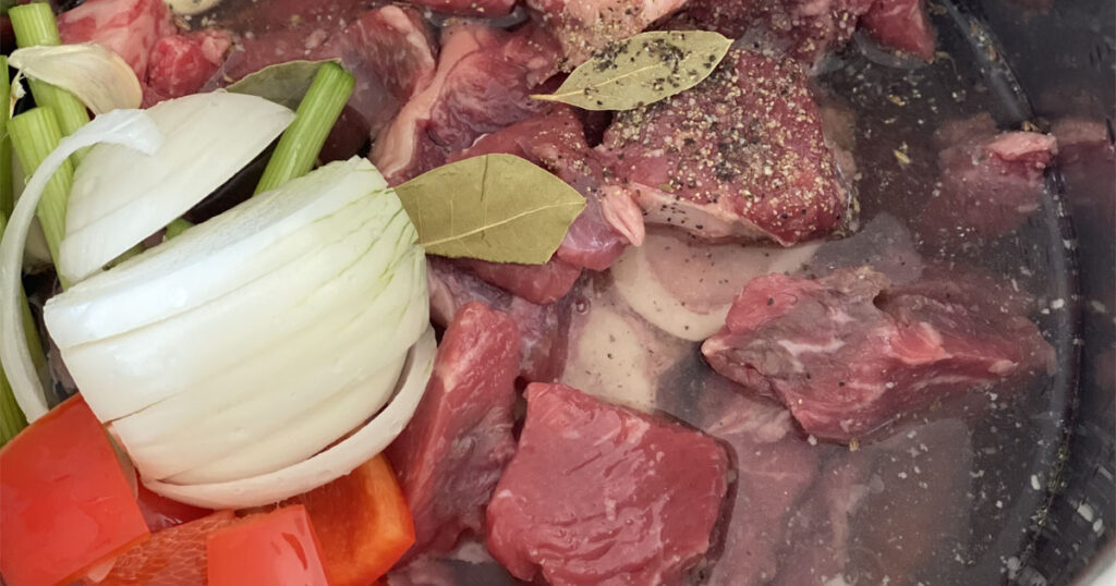 Instant Pot with raw beef and vegetables