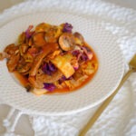 Round plate with beef, tomato sauce, mushrooms, and cabbage