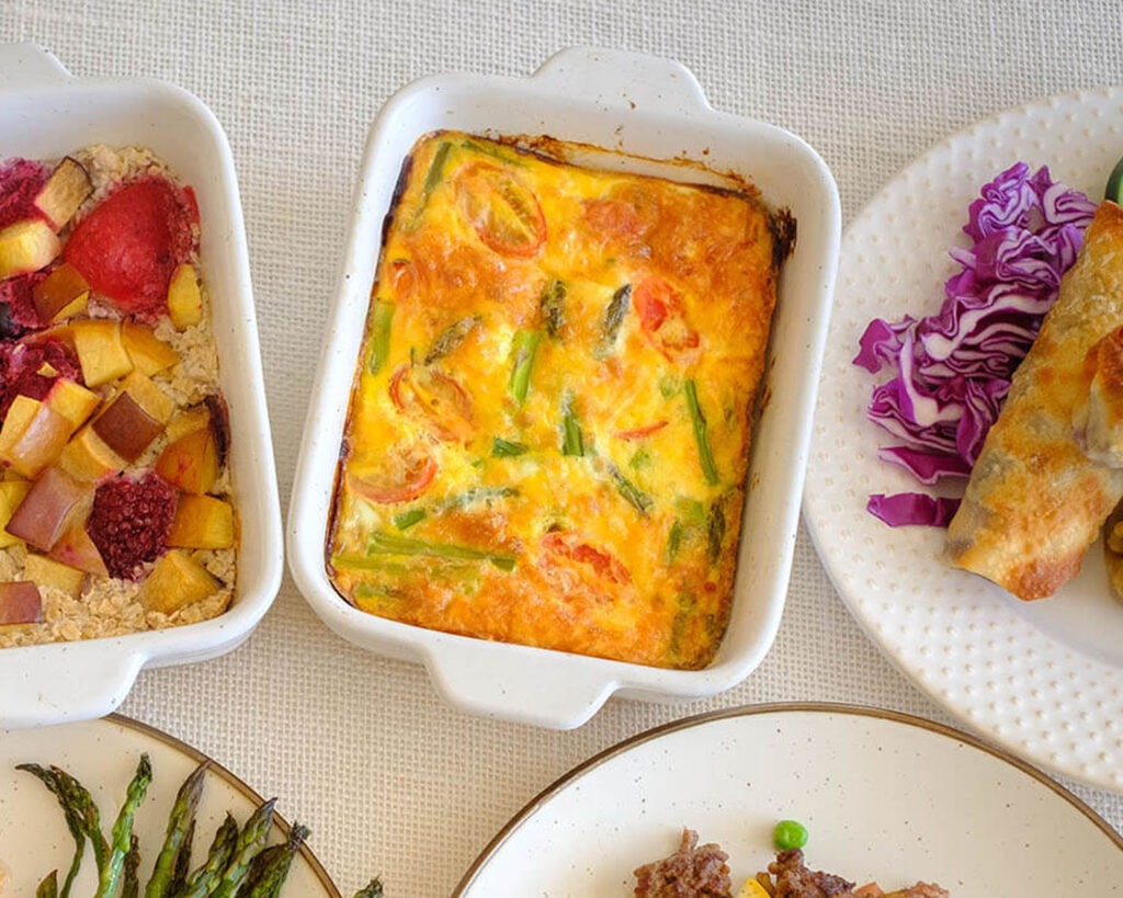 white rectangular baking dish with asparagus and tomato egg frittata - part of a healthy breakfast routine