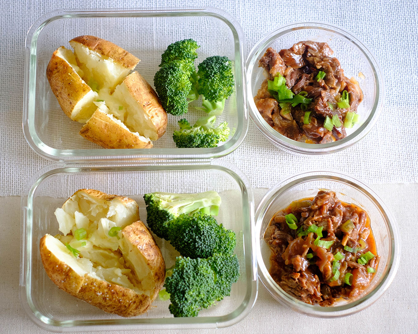 glass meal prep containers with peanut butter quesadillas and sliced green apples