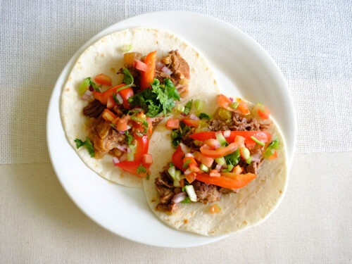 round plate with beef soft tacos