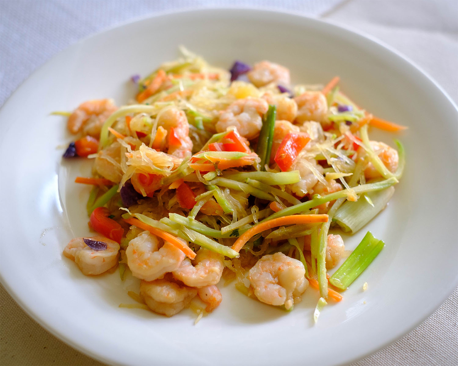 shrimp with spaghetti squash in round plate