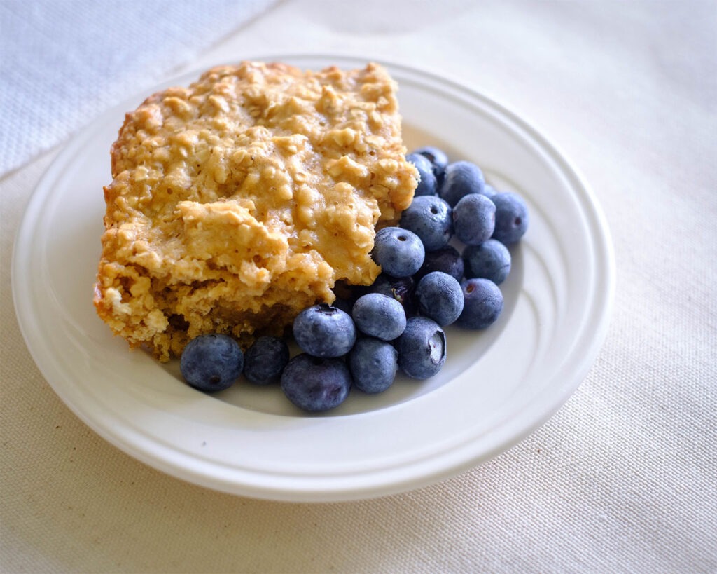round plate with honey oat muffin bars and blueberries
