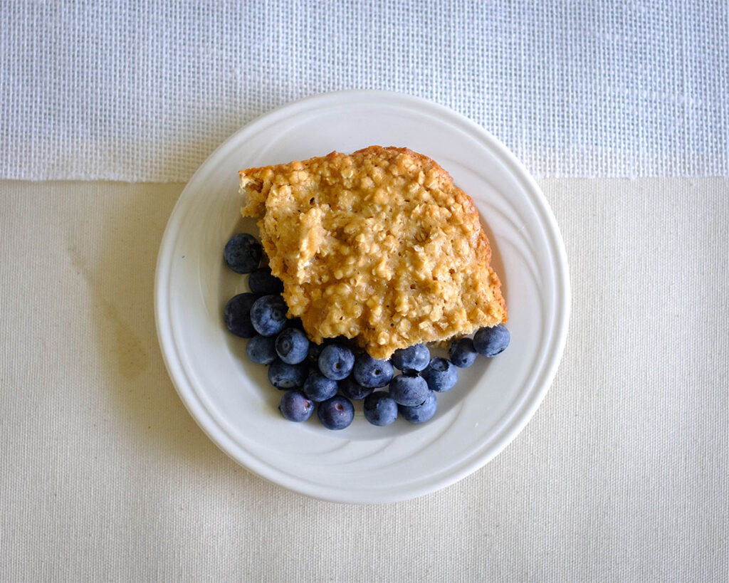 round plate with honey oat muffin bars and blueberries