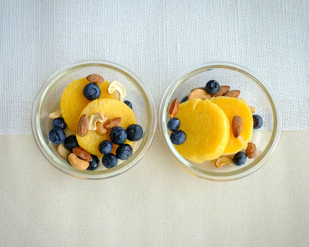 polenta pancakes with berries and nuts in a bowl