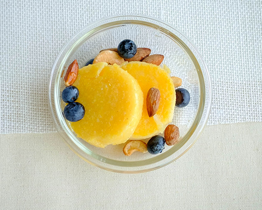 polenta pancakes with berries and nuts in a bowl