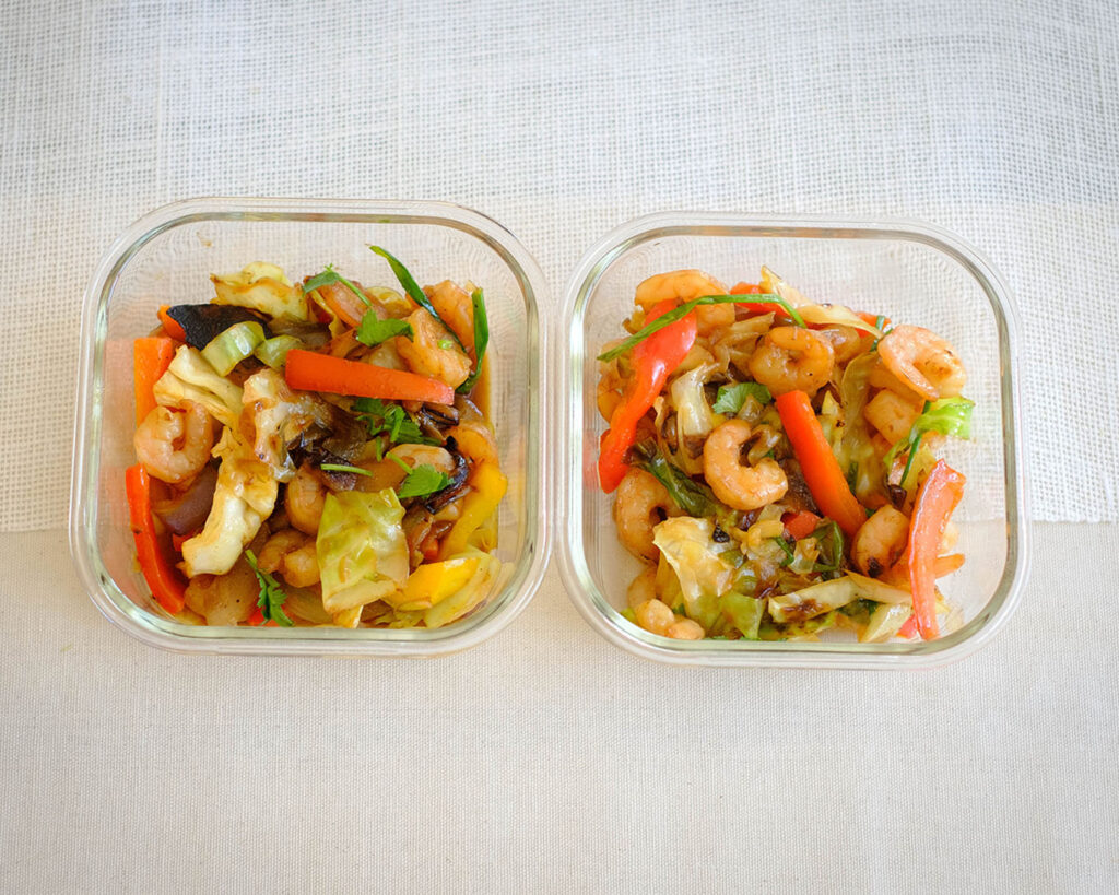 shrimp and cabbage stir fry in meal prep containers