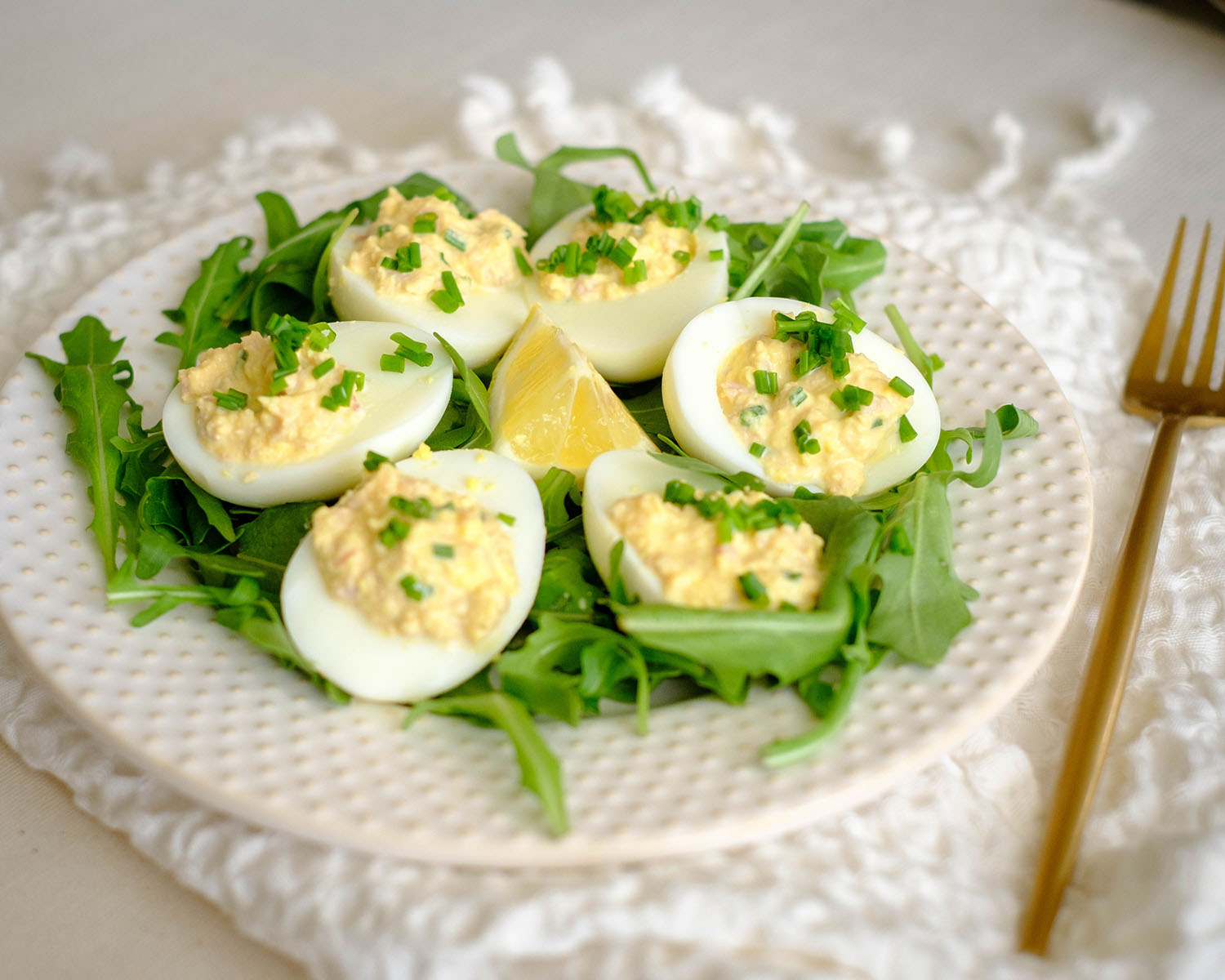 round plate with deviled eggs and arugula salad