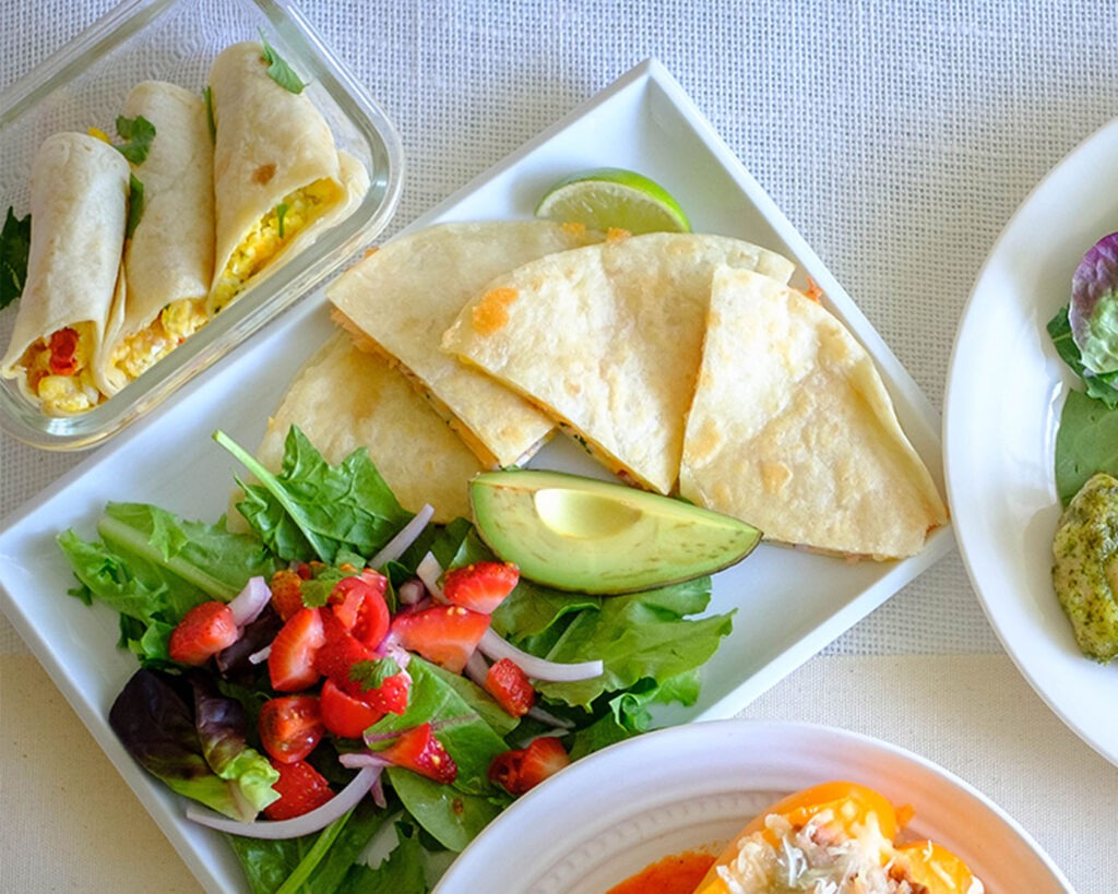 plate with salmon quesadilla and strawberry salsa salad
