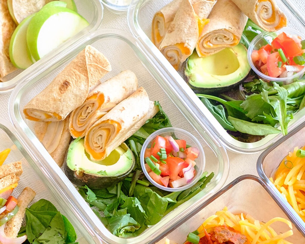 meal prep containers with turkey and cheese air fryer lunch taquitos with pico de gallo, avocado, and spring mix