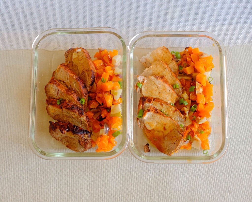 meal prep containers with sliced pork tenderloin and diced butternut squash