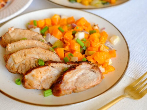 round plate with sliced pork tenderloin and diced butternut squash
