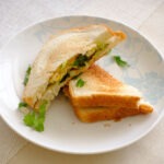 round plate with avocado and egg sandwich