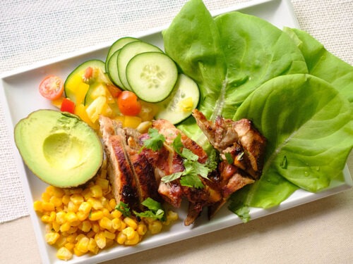 rectangle plate with corn, avocado, grilled chicken, cherries, cucumbers, and lettuce