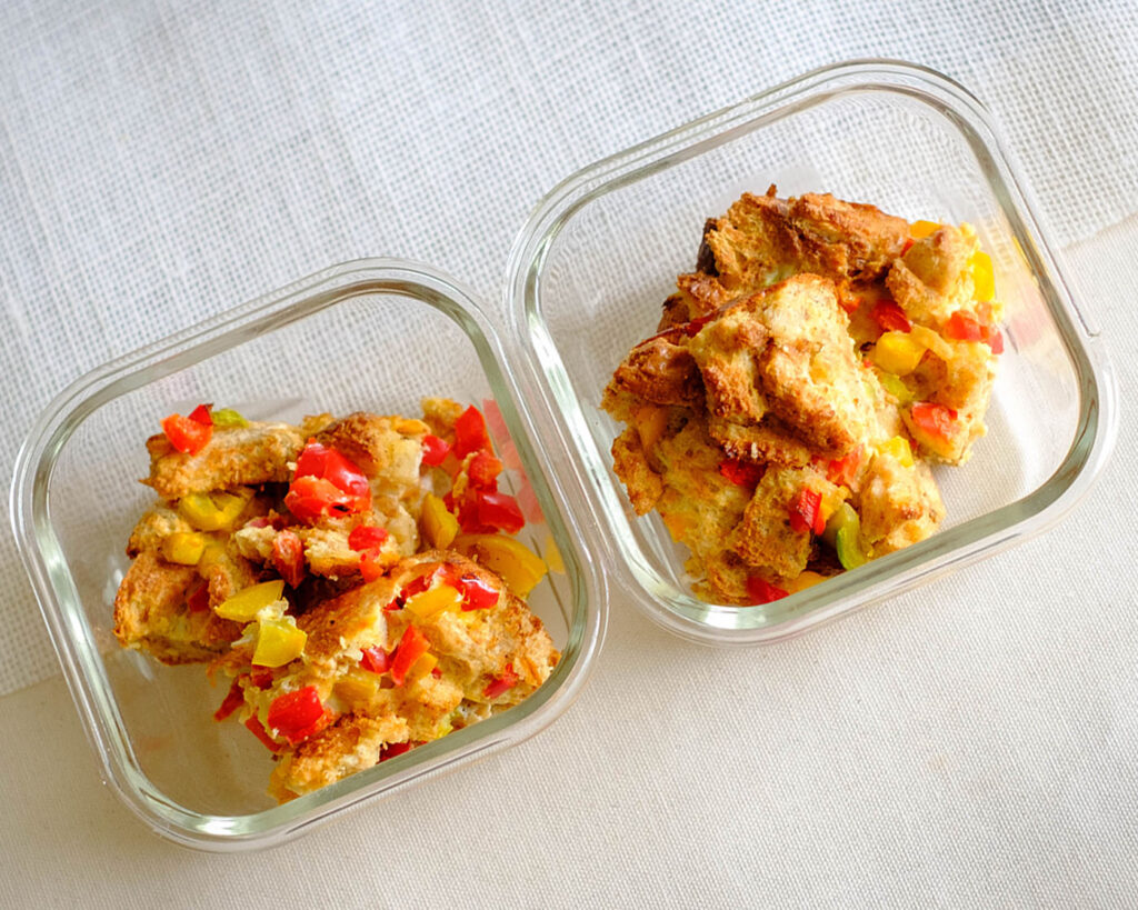 glass meal prep containers with bread pudding with bell peppers