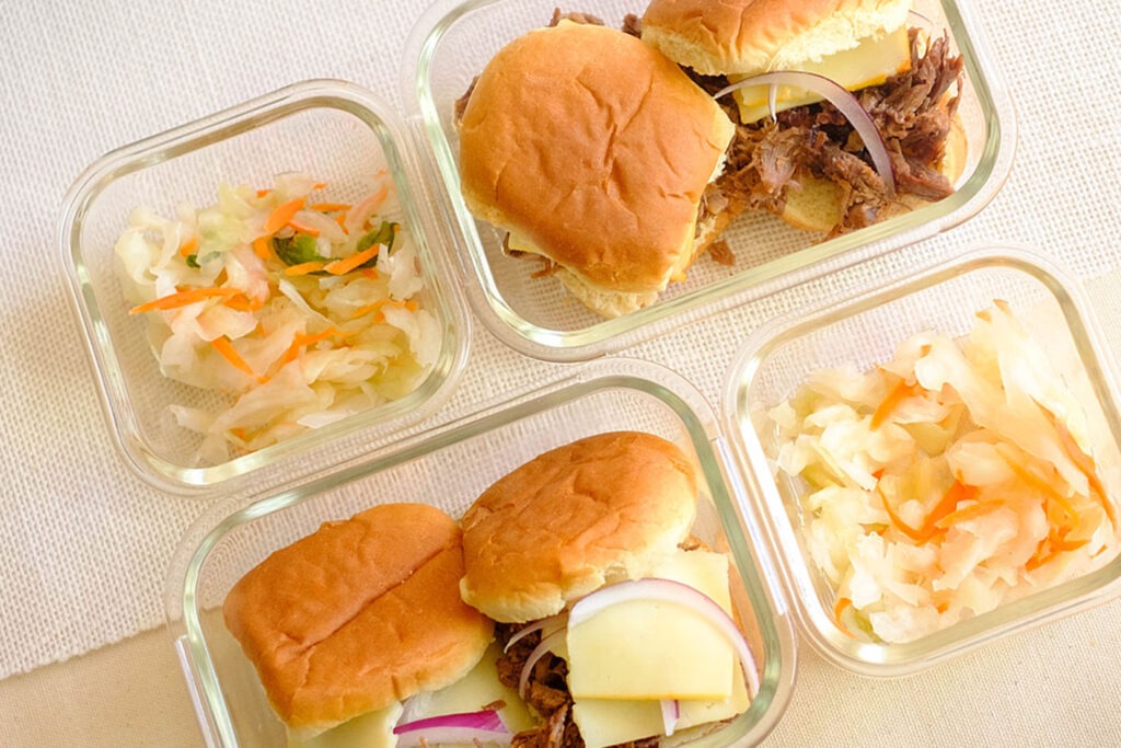 glass meal prep containers with bbq beef sliders and coleslaw