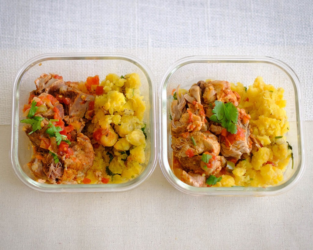 glass meal prep containers with shredded pork with mashed plaintains