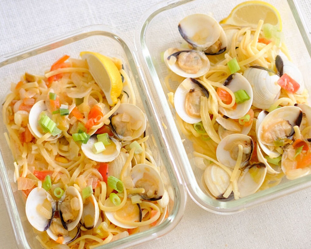 glass meal prep container with linguine pasta and clams