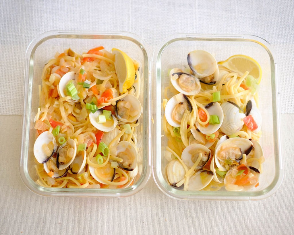 glass meal prep container with linguine pasta and clams