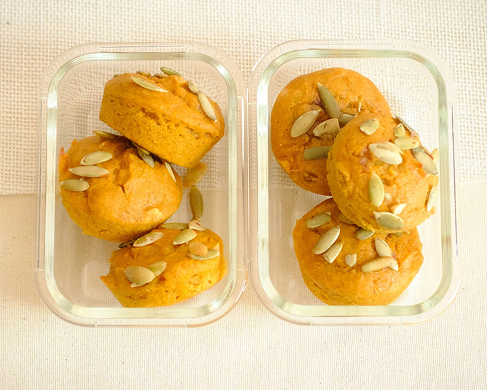 glass meal prep containers with pumpkin muffins