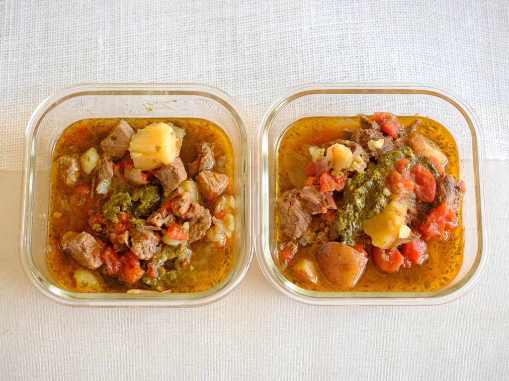 glass meal prep containers with basil beef stew with diced tomatoes and potatoes