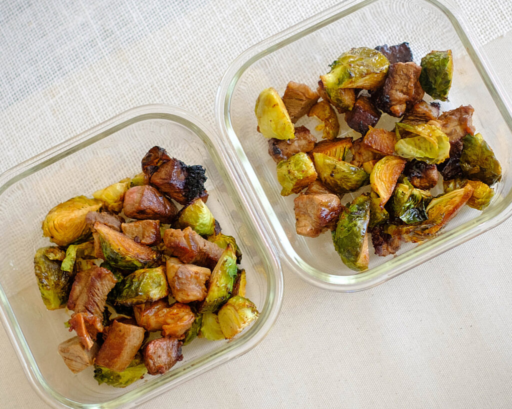 glass meal prep containes with steak cubes and brussel sprouts