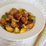 round plate with steak cubes and brussel sprouts