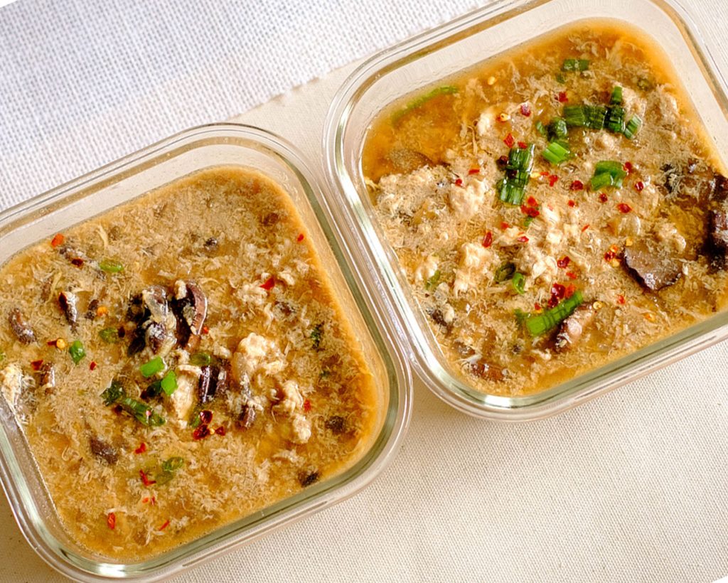 rectangular meal prep containers of hot and sour soup