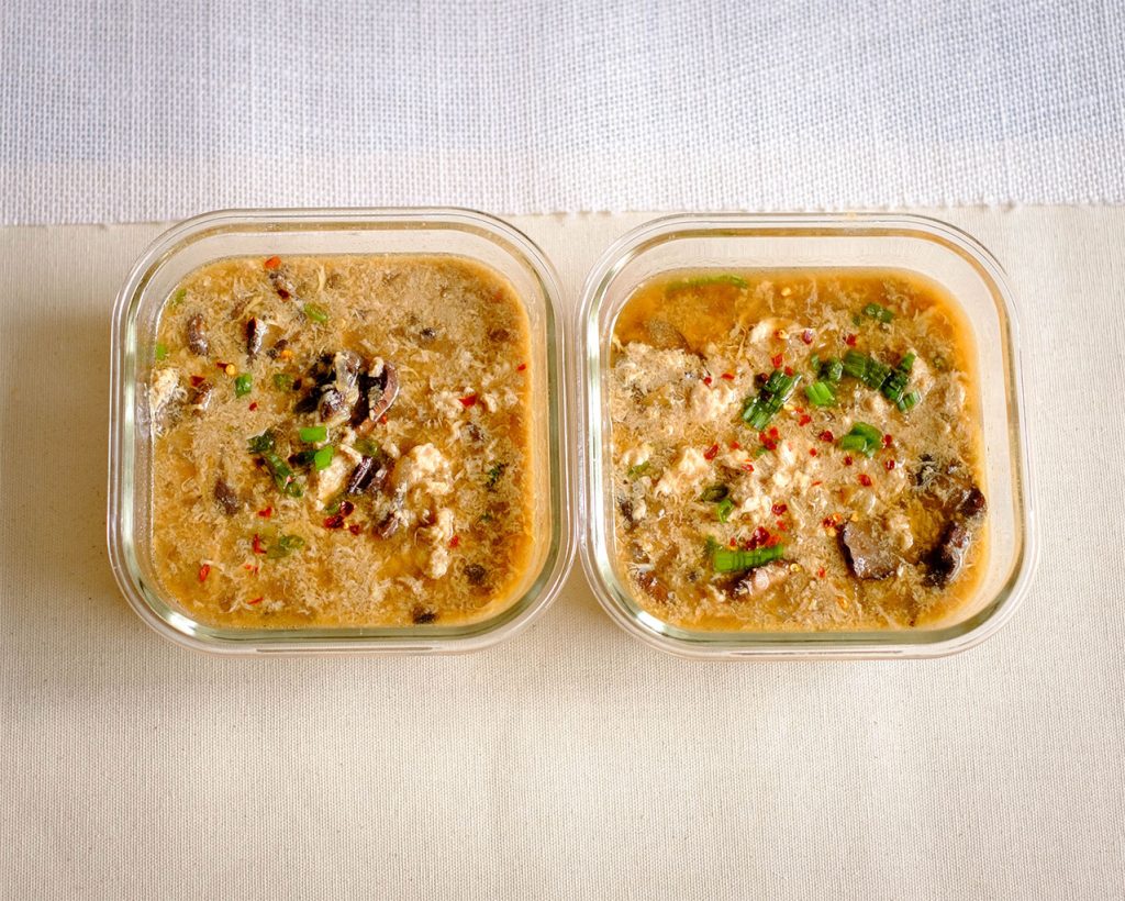 rectangular meal prep containers of hot and sour soup