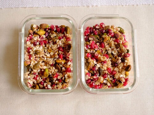 rectangular glass meal prep container with pistachios, pomegranate, and rolled oats