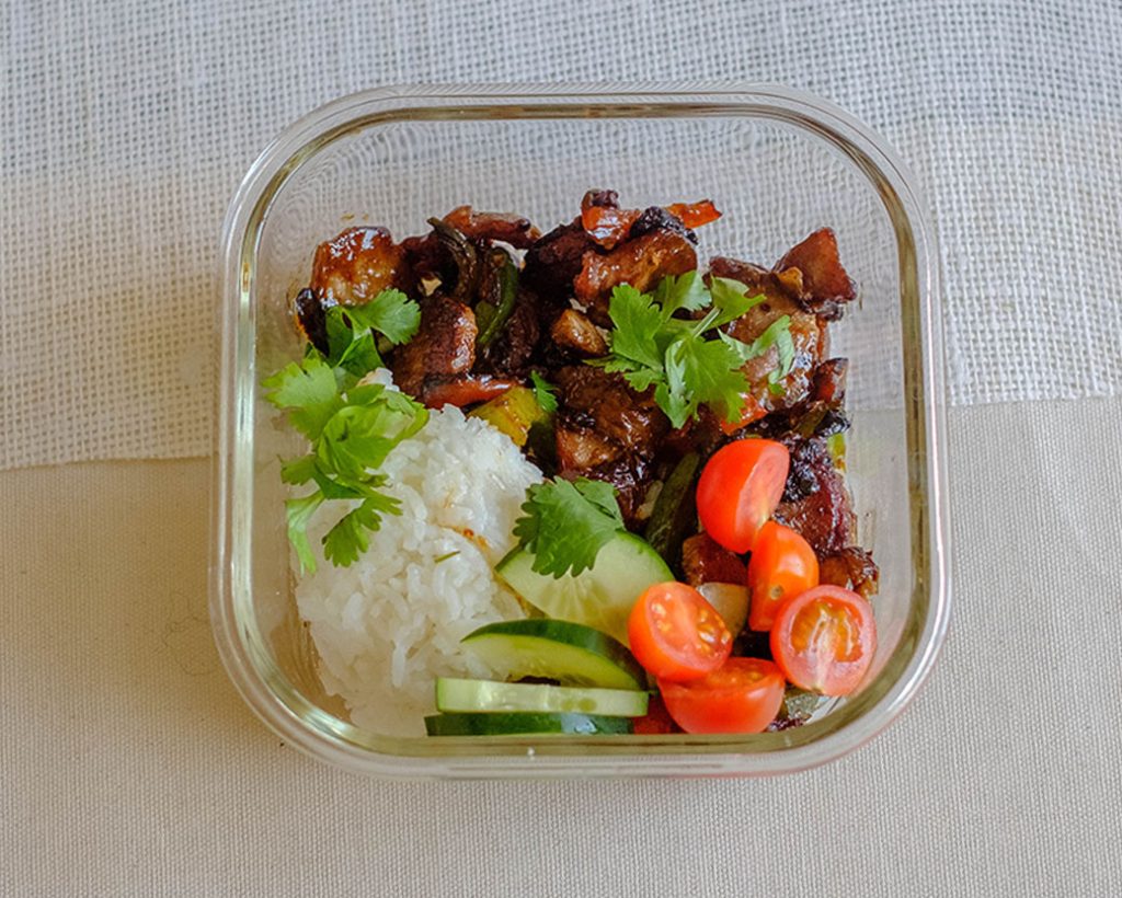 rectangular plate with pork stir fry and vegetables with white rice