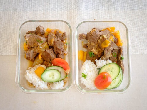 rectangle glass meal prep containers with teriyaki beef stew, white rice, cucumber, and sliced tomato