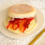 round plate with english muffins, bacon slices, and sliced cheese