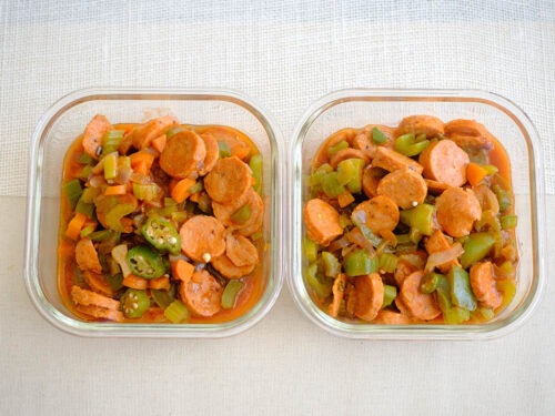 square meal prep containers with cajun sausage stew in tomato sauce with okra and green bell peppers