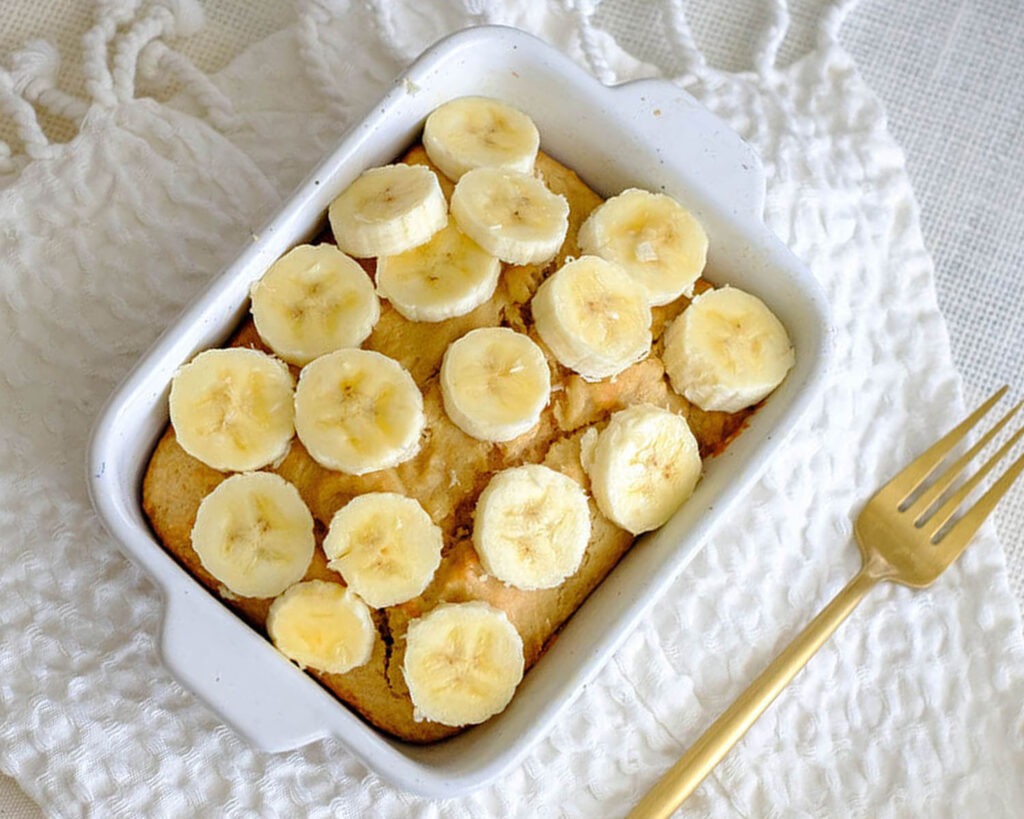 rectangle baking dish with peanut butter muffin bars with banana slice topping