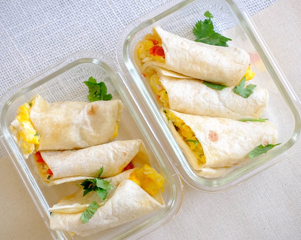 breakfast egg burritos rolled up in a meal prep container