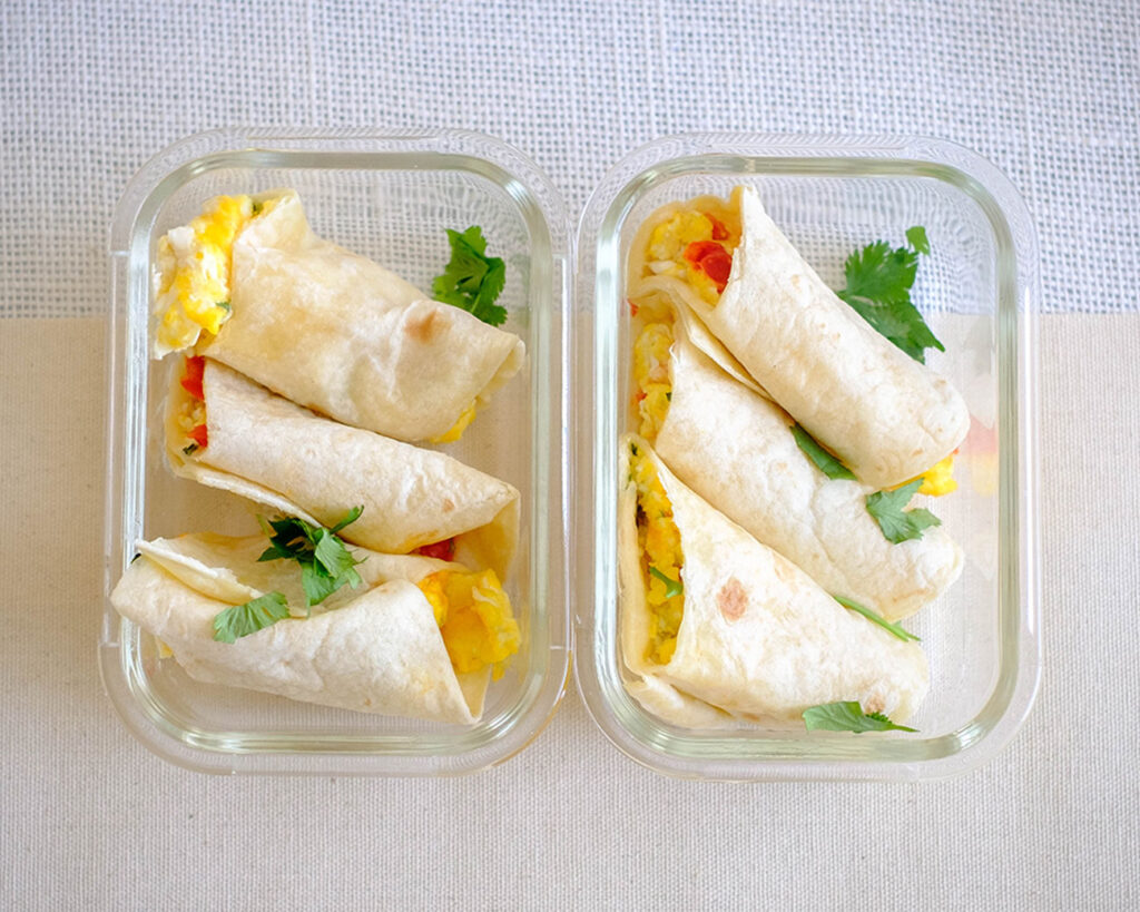 breakfast egg burritos rolled up in a meal prep container
