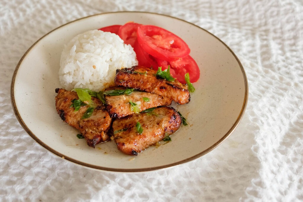 pork loin slices with white rice and sliced tomatoes