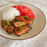 pork loin slices with white rice and sliced tomatoes
