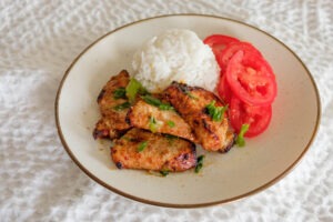 pork loin slices with white rice and sliced tomatoes