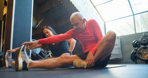 fitness coach and client stretching